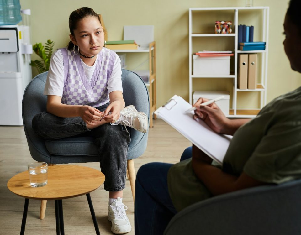 Girl having consultation with psychologist