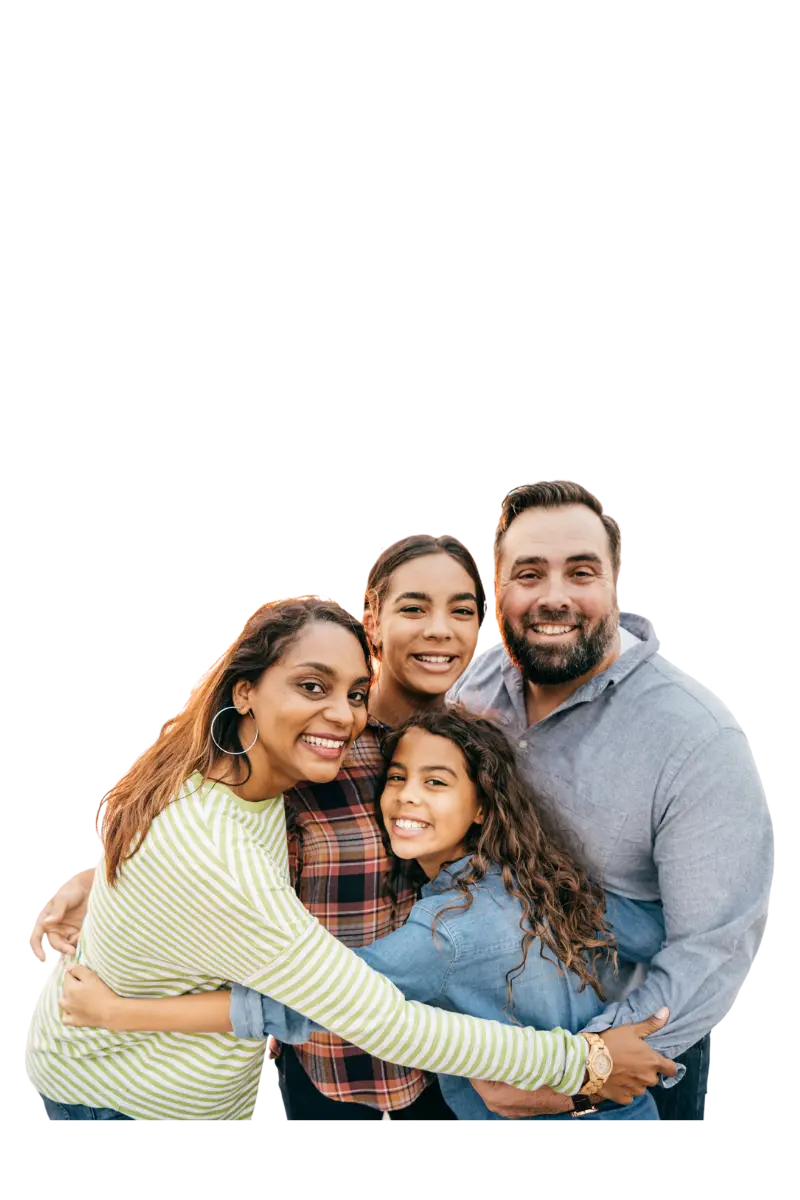 Family of four embracing and smiling.