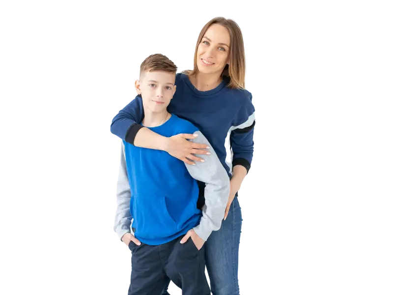 Mother and son standing together smiling.