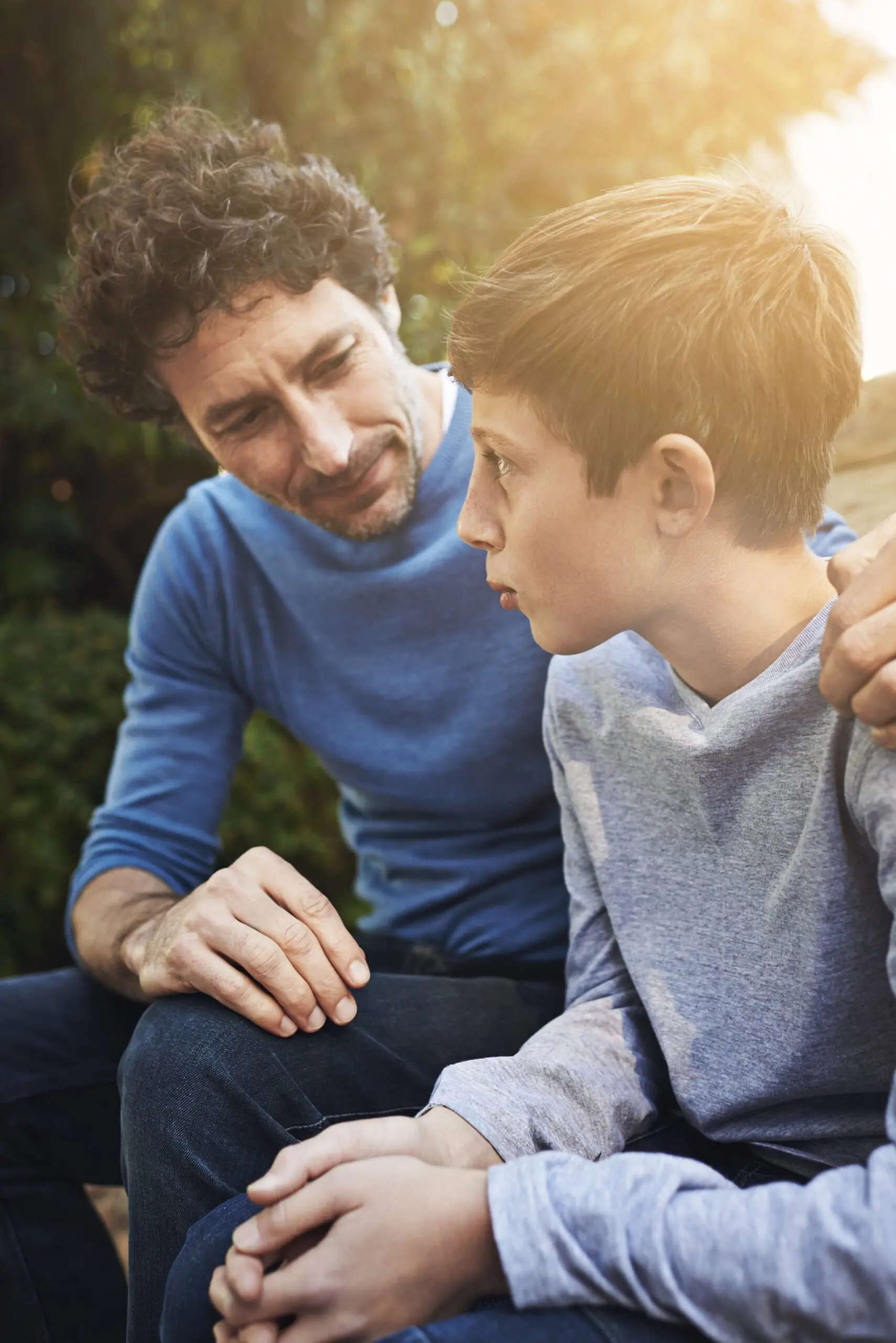 Adult and teen boy talking.