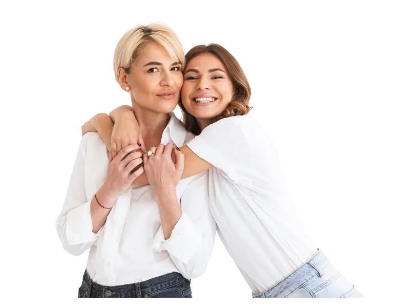 Two women embracing and smiling.