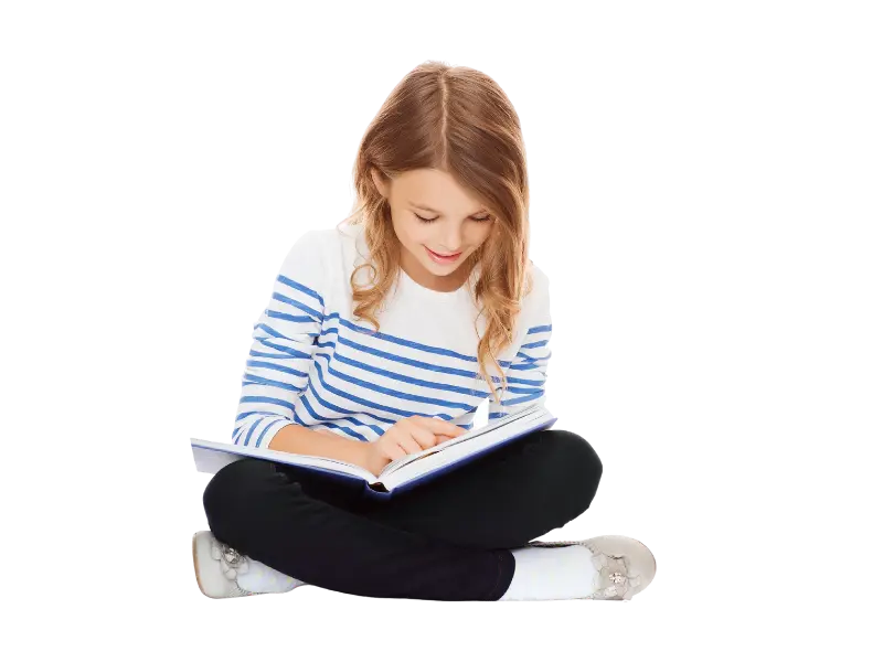 Young girl sitting on the floor reading a book.