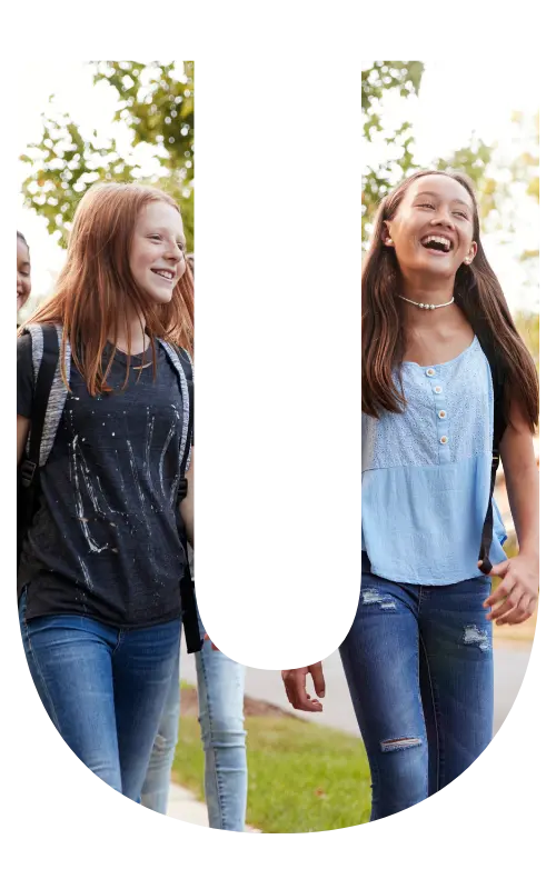 Image is in the shape of the letter "u" and features teen girls smiling and walking together.